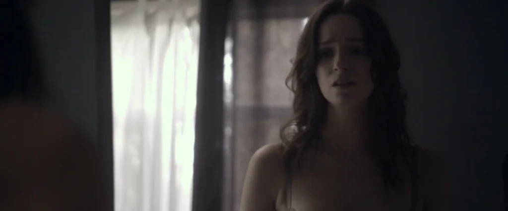 Sarah examines herself in the mirror in "Starry Eyes".